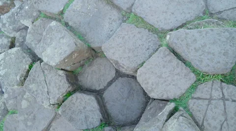Round rock columns with the green grass Stock Footage