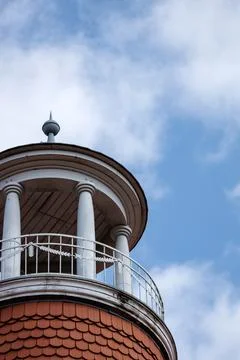 Round Rooftop Pavilion with White Columns Against a Soft Blue Cloudy Sky Foto stock