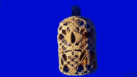 Round rotating bottle with knot of rope Stock Footage 87932134
