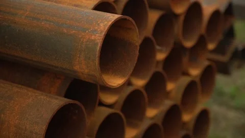 Round rusted pipes lying outside the finished product warehouse Stock Footage 237939626