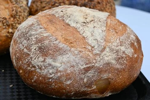 Round rustic bread loaf dusted with flour Stock Photos