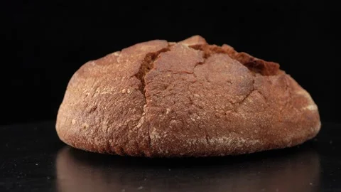 Round rye bread close up on black background Stock Footage 140415110
