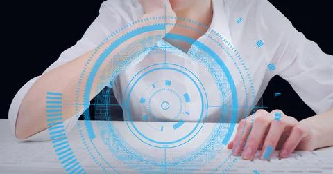 Round scanner against mid section of woman using computer against black Fotos de archivo