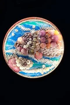 Round seashell beach artwork on black background Stock Photos