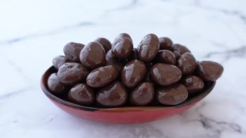 Round shape chocolate candy in blue and brown color in a bowl Stock Footage 265834702