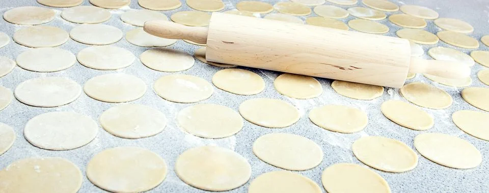 Round shape of the dough and rolling pin with flour on the table Stock-Fotos