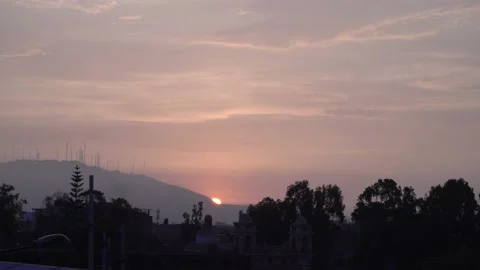 Round shape sunset in real time hiding behind a hill with antennas 스톡 동영상 145761069