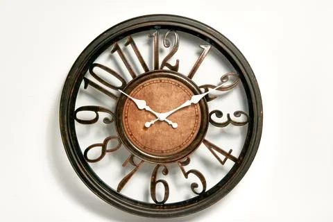 Round shape wall clock on a white background. Stock Photos