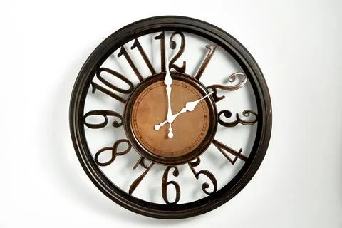 Round shape wall clock on a white background Stock Photos