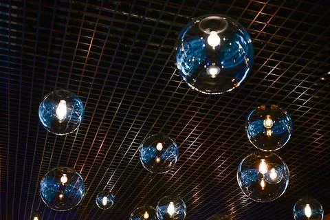 Round-shaped LED lamps on the ceiling in the interior of the restaurant Stock Photos