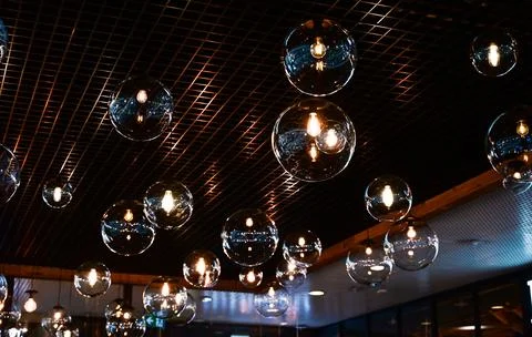 Round-shaped LED lamps on the ceiling in the interior of the restaurant Stock Photos