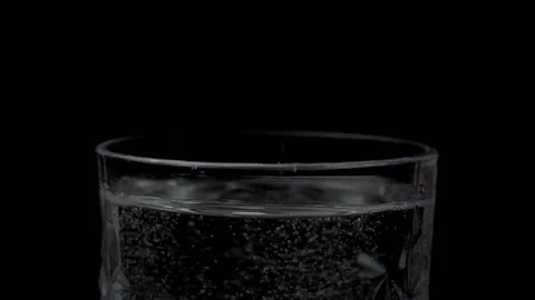 Round shaped medicine dropping / falling in a clear glass of water - treatmen... Stock Footage 153827639