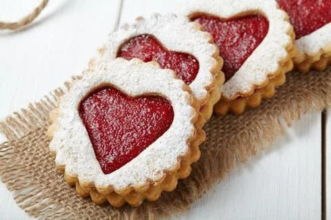 Round shortbread cookies with heart shaped jam close-up composition for Stock Photos