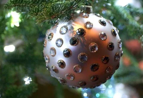 A round silver embedded crystal ornament on the Christmas tree Stock Photos