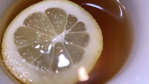 Round slice of lemon in a mug of hot tea Stock Footage 125509684
