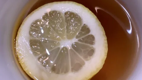 Round slice of lemon in a mug of hot tea Stock Footage 125535696
