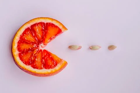 A round slice of red orange, three seeds Stock Photos