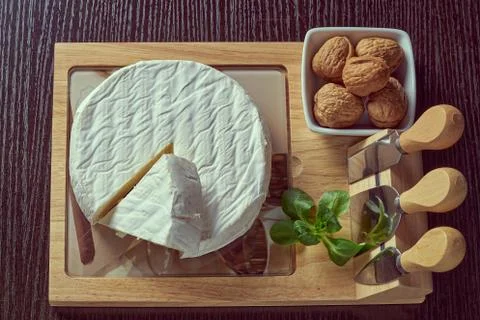 Round soft cheese, with a section cut. Stock Photos