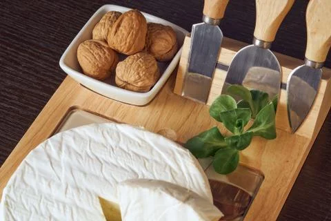 Round soft cheese, with a section cut. Stock Photos