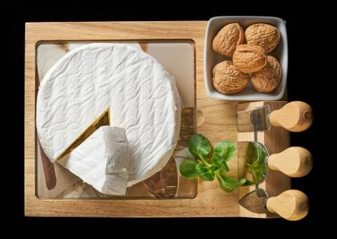 Round soft cheese, with a section cut. Stock Photos