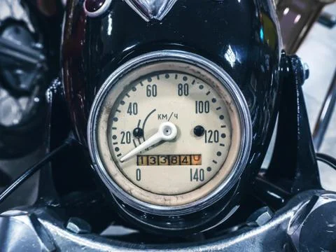 Round speedometer of an old Soviet black motorcycle. Closeup photo Stock Photos