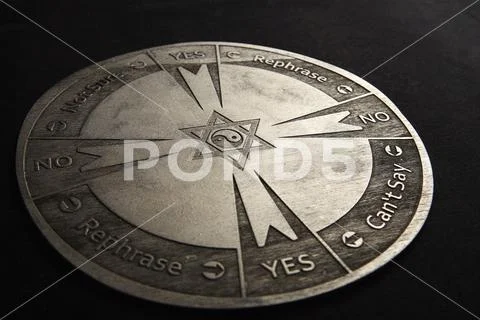 Round spiritual chart carved to wood used for communication with pendulum Stock Photos