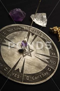 Round spiritual chart carved to wood used for communication with pendulum Stock Photos