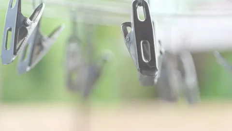 Round steel clothesline slow motion bright green bokeh background. Stock Footage 201254375