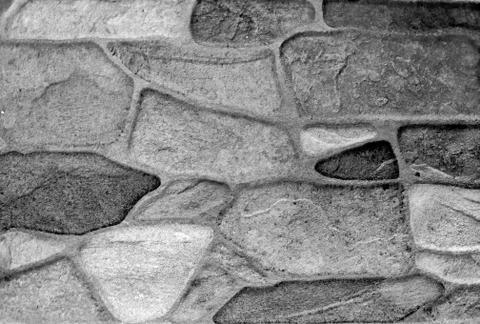 Round stone wall texture in different sizes and colors shades of gray white a Stock Photos