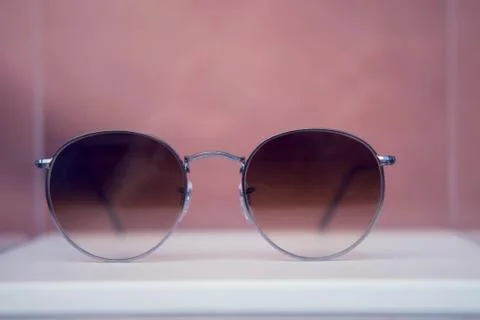 Round sunglasses in silver metal frames close up on a store shelf Stock Photos
