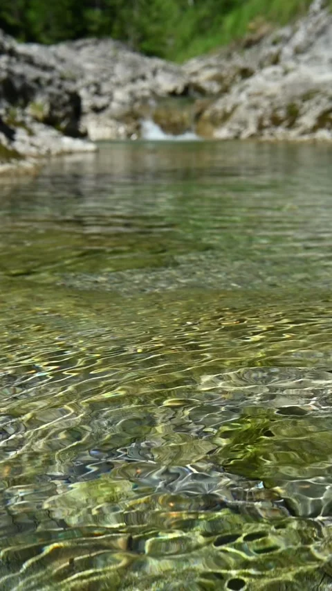 Round sunlight effects on the ground of a mountain stream in summer, vertical Stock-Footage 260879223