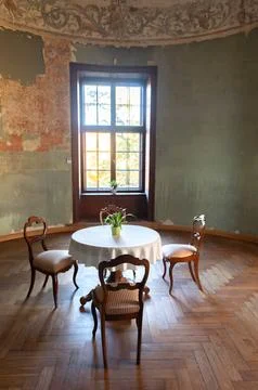 A round table and three chairs in the rooms of an ancient medieval castle, .. Stock Photos