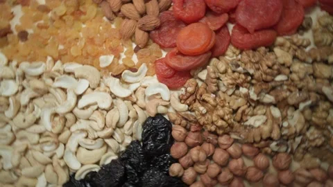 Round table filled with nuts and dried fruits. The benefits or harms Vídeo Stock 169096439