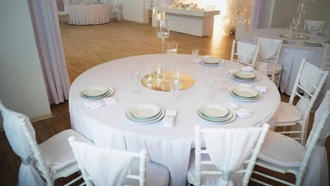 A round table in the foreground is a round table covered with a tablecloth and Stock Footage 97717392