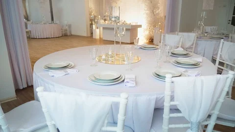 A round table in the foreground is a round table covered with a tablecloth and Stock Footage 97717488