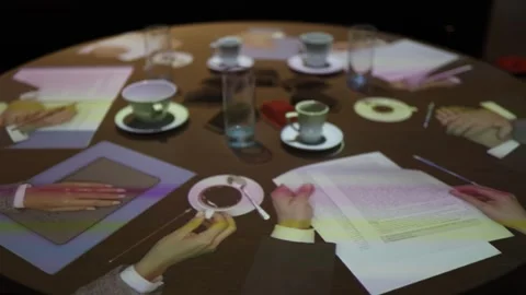 A round table with holographic projections of hands symbolizes a virtual meeting Stock Footage 290184859