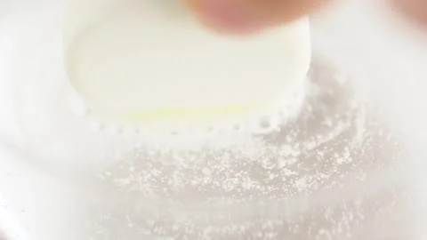 Round tablet of soluble aspirin bubbling in glass of water, macro shot. Eff.. Stock Footage 267878733