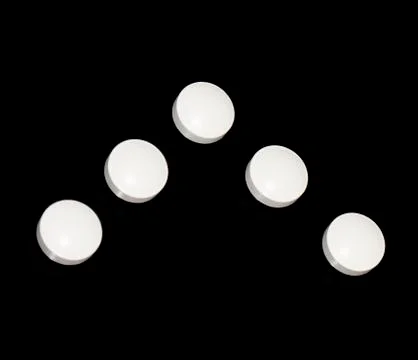 Round tablets in a low key Stock Photos