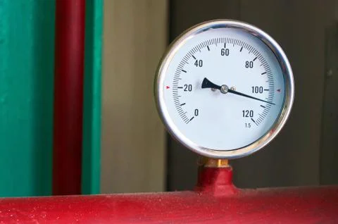 Round temperature sensor on the hot water pipe. Stock Photos
