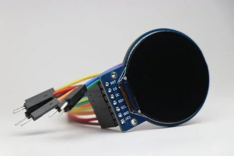 Round TFT LCD screen connected with jumper cables used in electronic projects Stock Photos