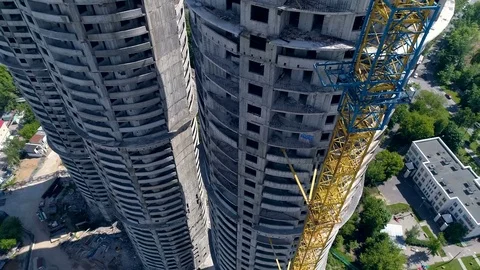 A round tower beside a crane with a small counterweight. Stock Footage 77196963