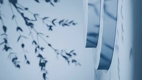 Round vertical podium casting leaf shadows on blue background. Minimal studio Stock Footage 307171084