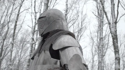 Round view of brave warrior wearing steel armor and helmet preparing for Stock Footage 86798441