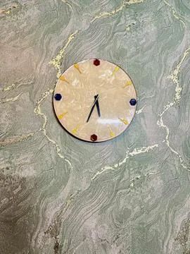 Round wall clock on textured green background Stock Photos