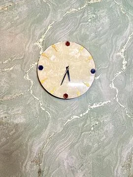 Round wall clock on textured green wall Stock Photos
