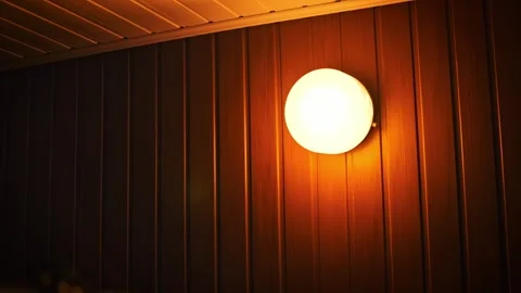 Round Wall Lamp with Diffuser on Wood Panel Wall Video stock 307312686