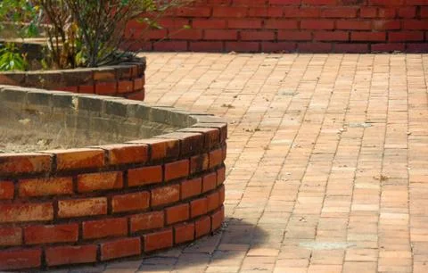 Round walls of rustic brick, on the brick floor Stock Photos