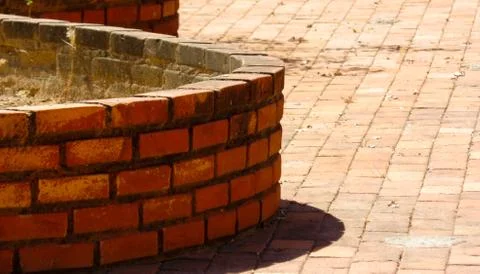 Round walls of rustic brick, on the brick floor Stock Photos