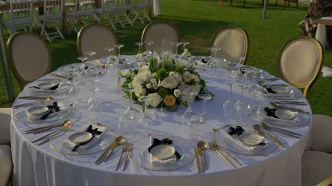 Round Wedding Table Set With White Floral Centerpiece And Gold Cutlery Stock-Footage 340595626