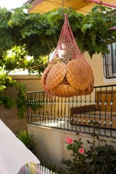 Round white bread hanging in a grid for drying Stock Photos